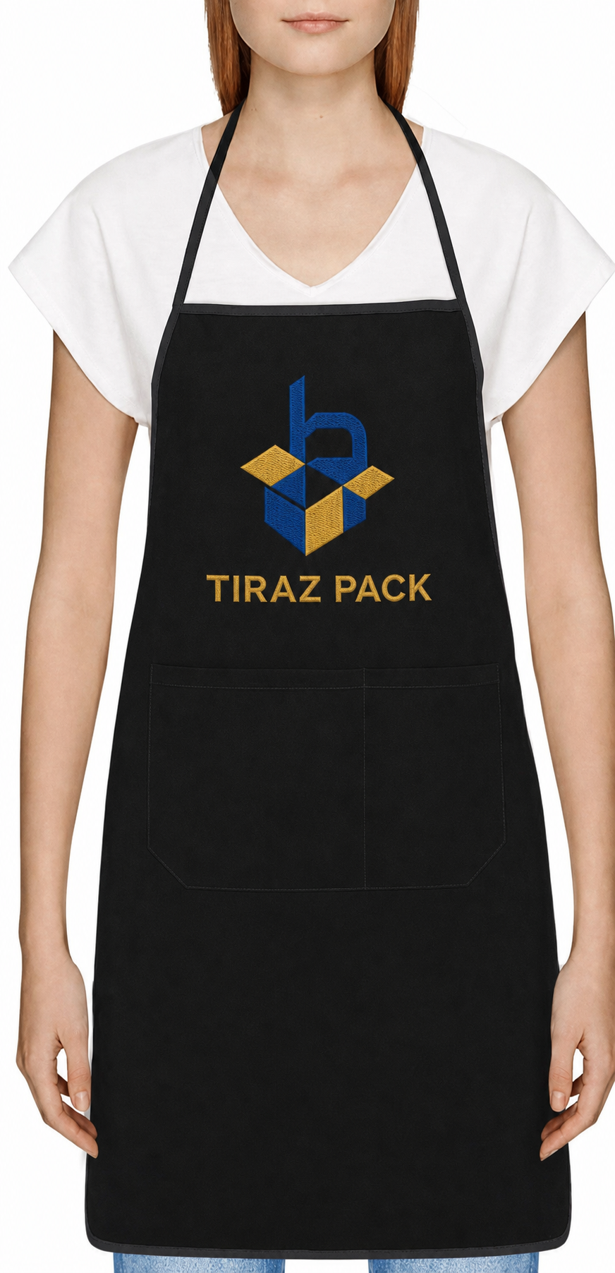 Close-up of Tiraz Pack logo and name embroidery on a black chef apron