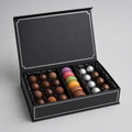Luxury black truffle and macaron box with silver foil details