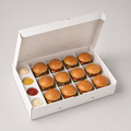 Premium white food-service box holding twelve sliders with four sauce compartments